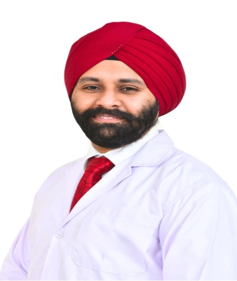 20 Picture 7 | Gurneet Portrait of a Sikh doctor wearing a red turban and white lab coat, smiling.